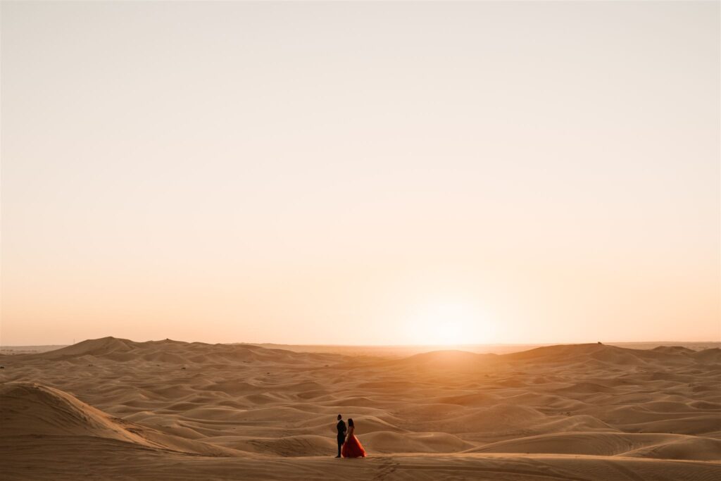 Couple walking in the desert of Dubai