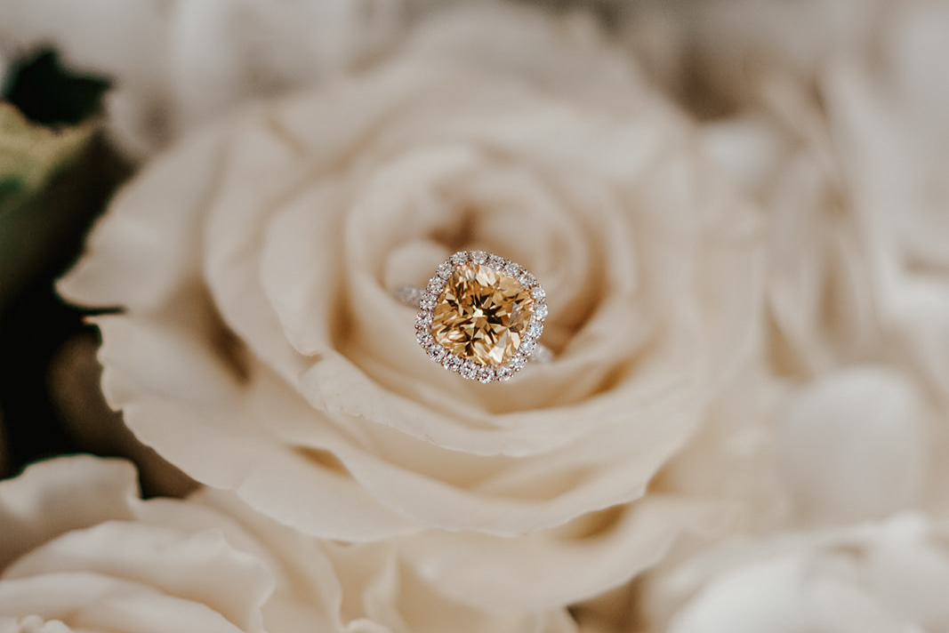 yellow diamond setting with halo in white roses proposal santorini