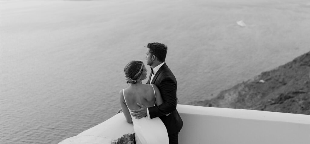couple looking at the santorini view black and white