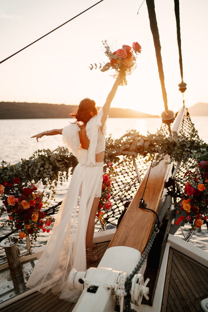 bride at sunset on boat in santorini