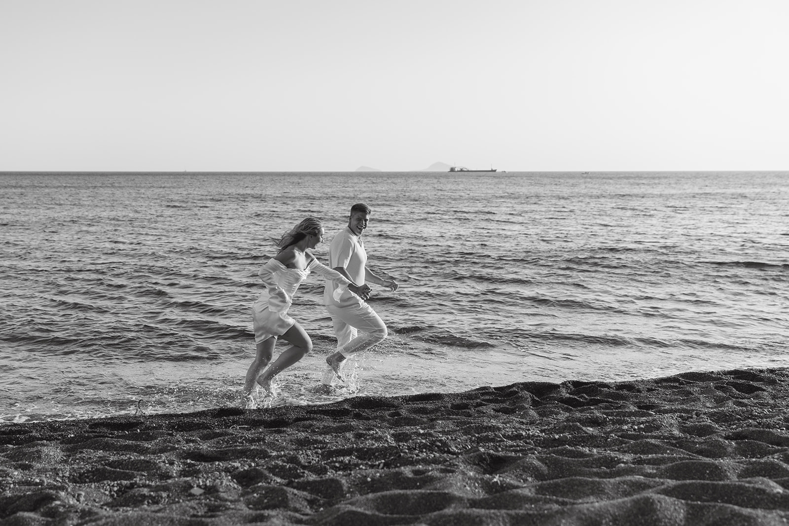 Romantic engagement photography, by the beach in Santorini